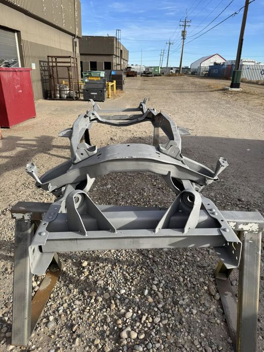 Vehicle subframe stripped to bare metal