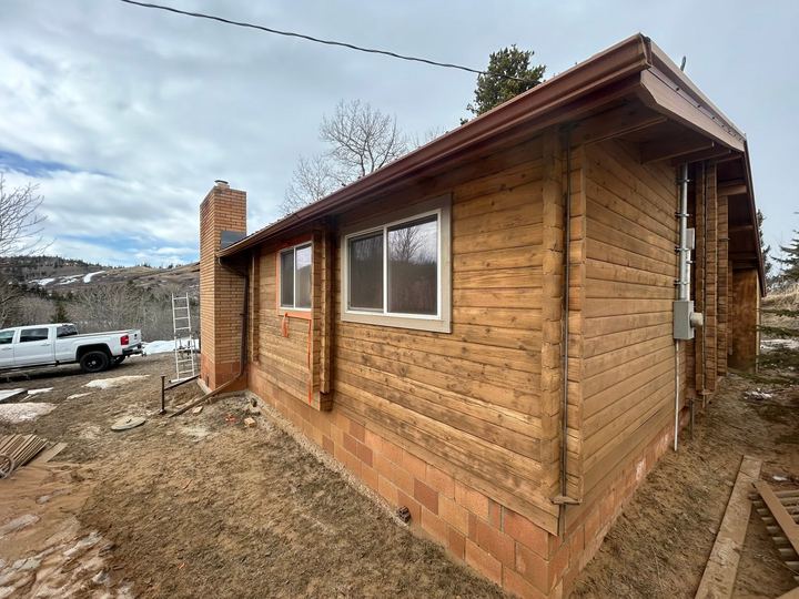 Log home exterior during restoration